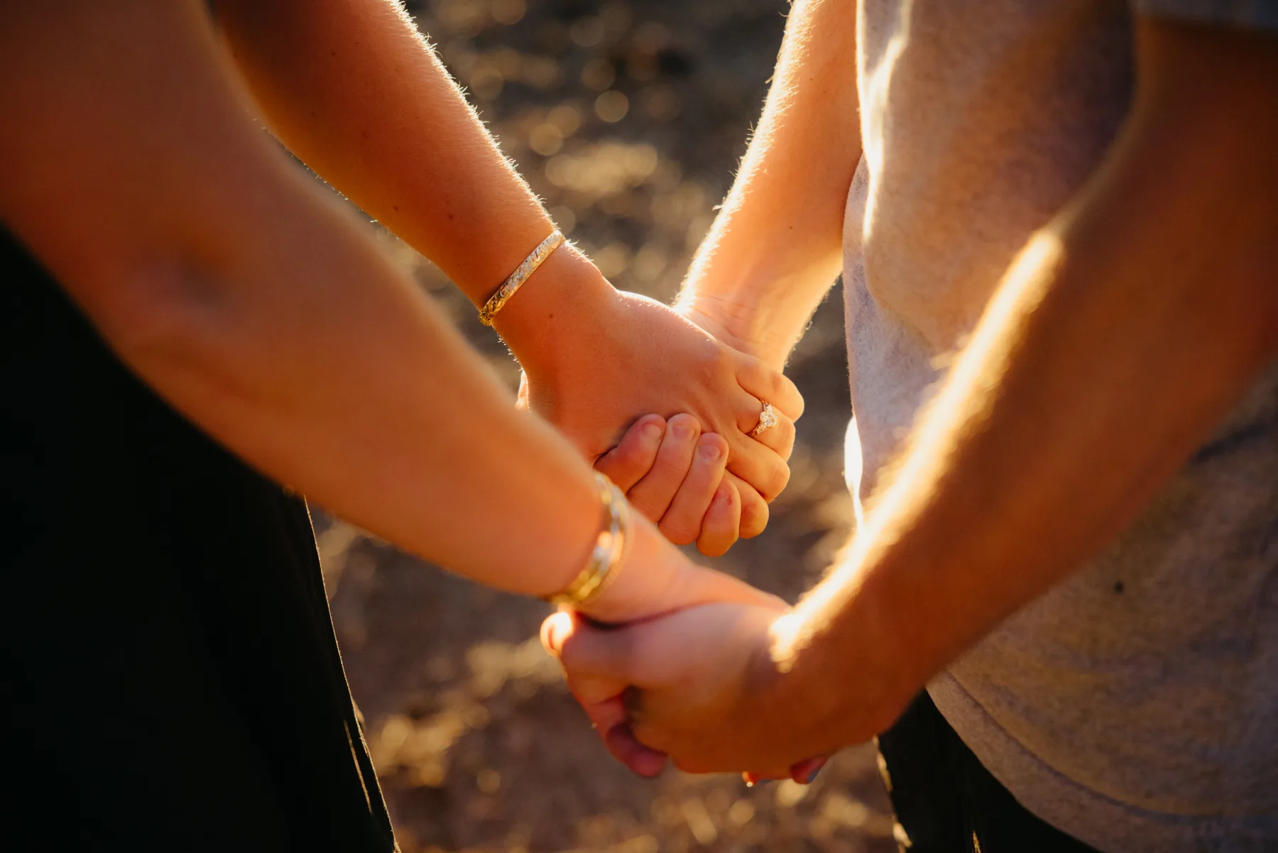 Two hands held together, a new ring catching the light