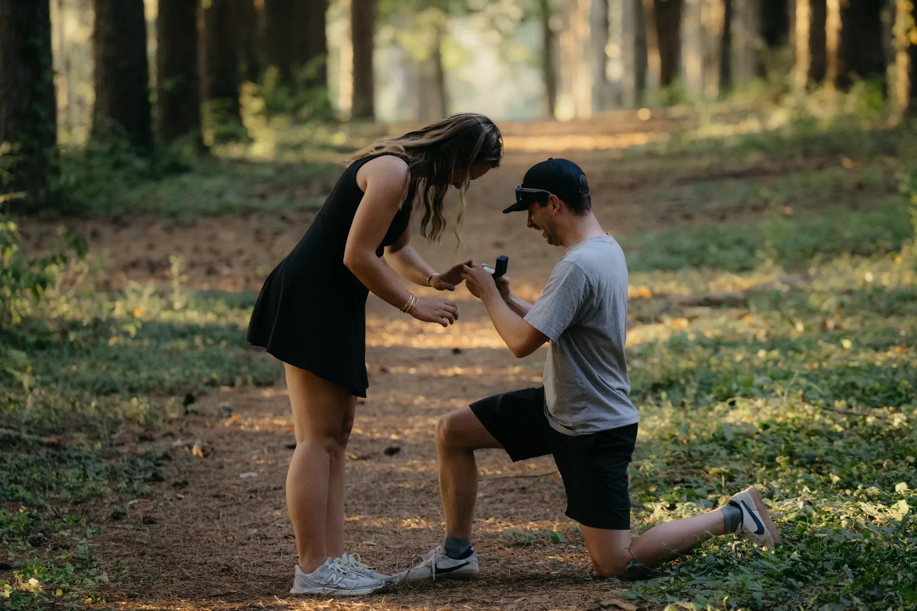 Down on one knee on the forest path
